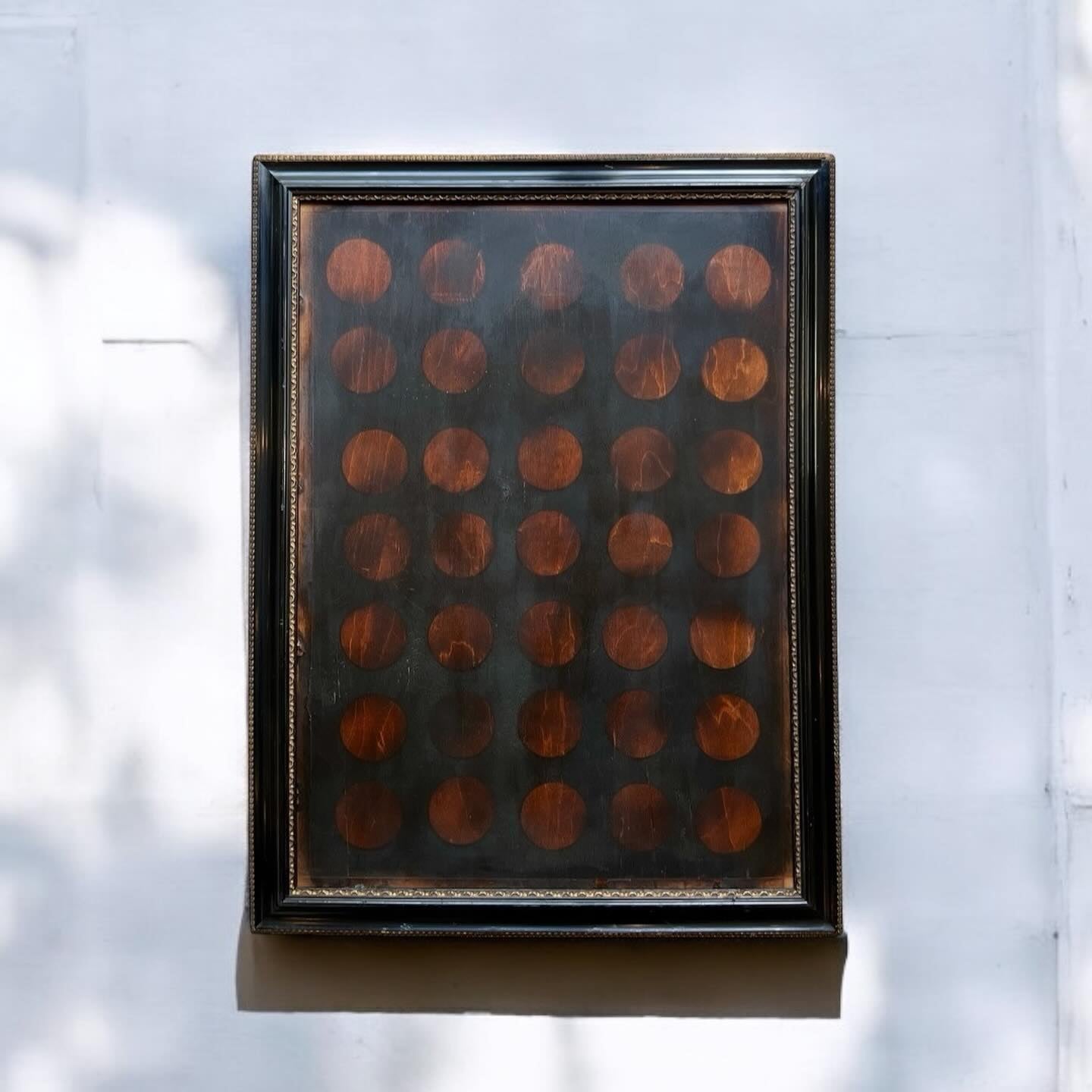 Rectangular dark frame with circular patterns on a light background