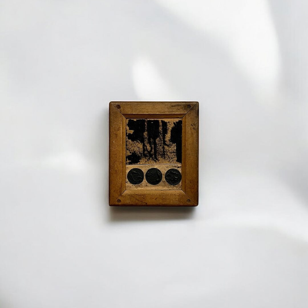 Small wooden frame with a dark interior on a white background