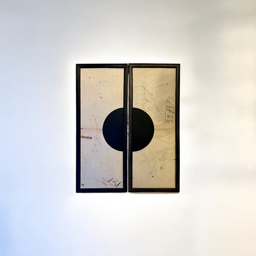 Two framed artworks on a white wall