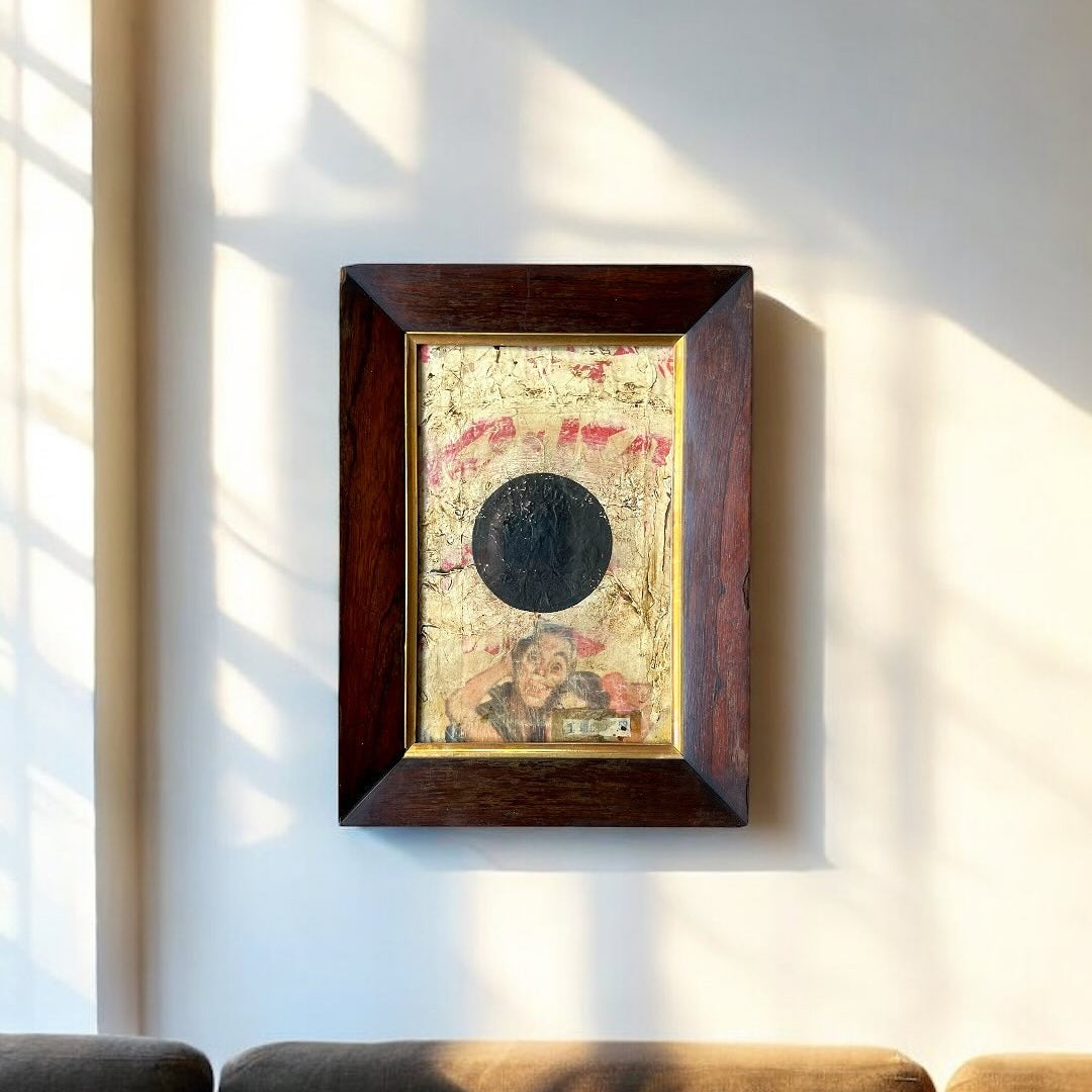 Framed artwork on a wall with sunlight casting shadows